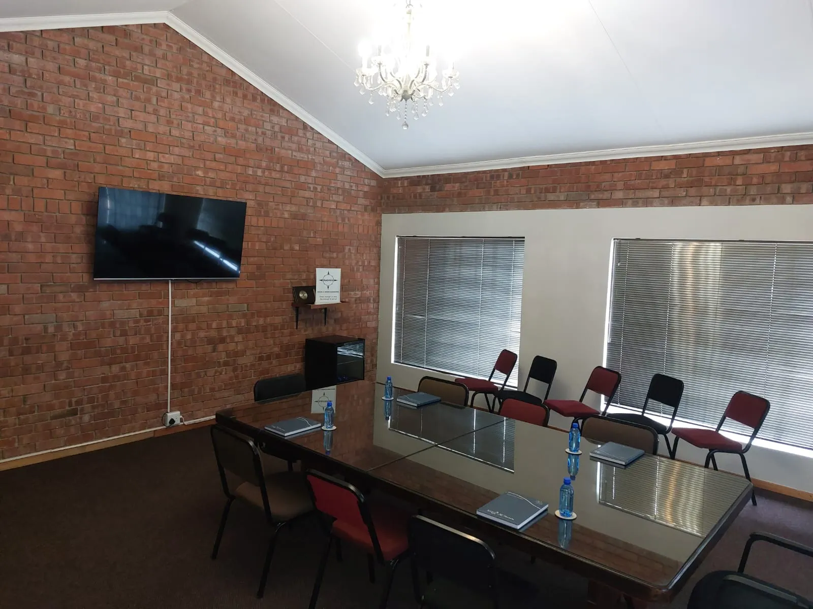 Radius boardroom with a meeting table, presentation screen and seating