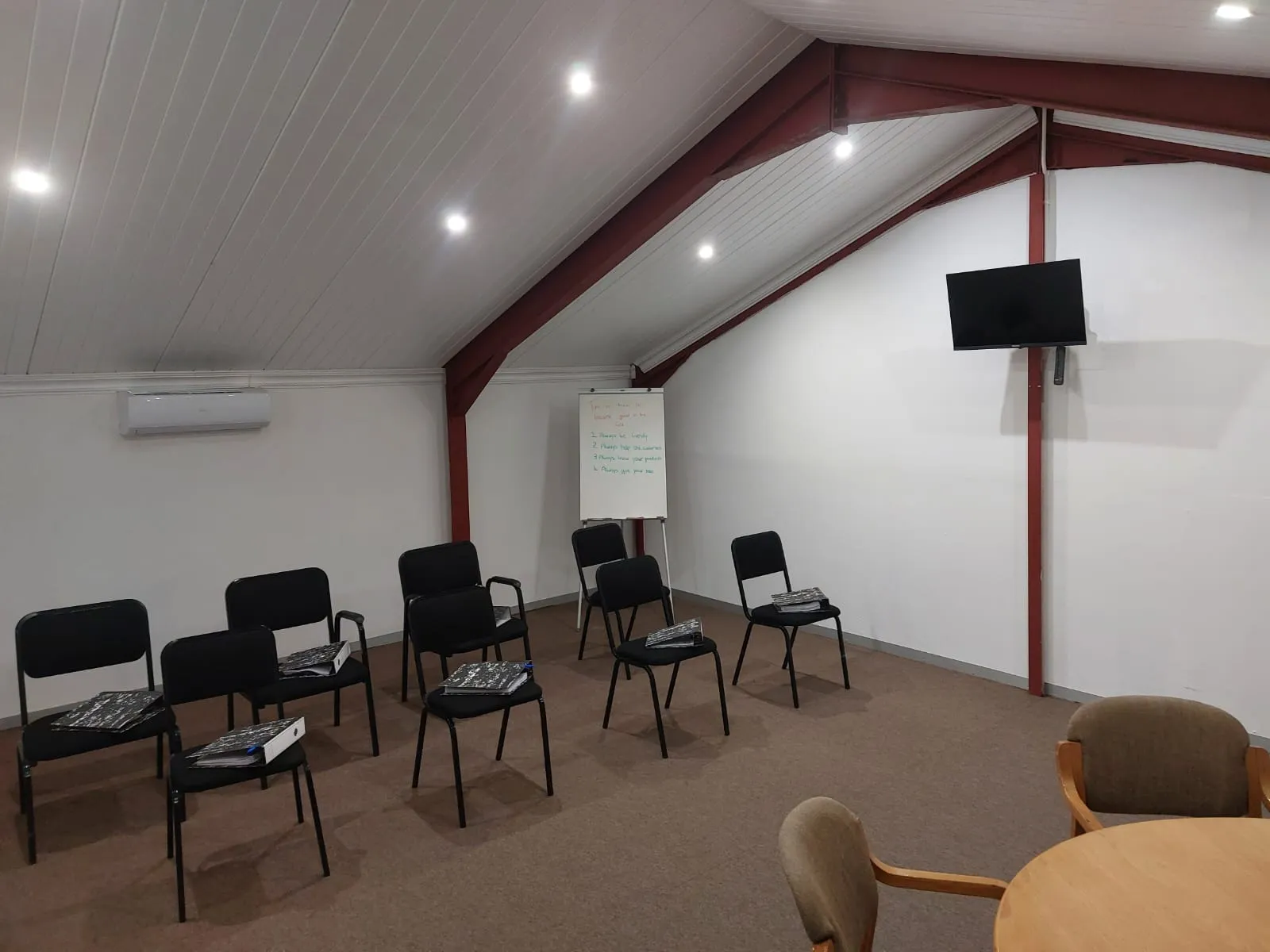 Radius training office arranged with chairs, workbooks and presentation equipment